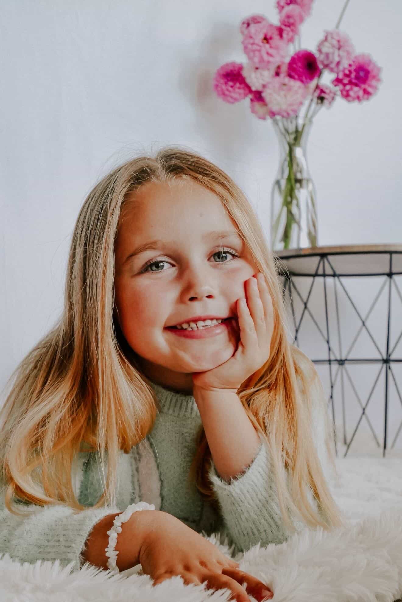 Child portrait with soft flowers in the background